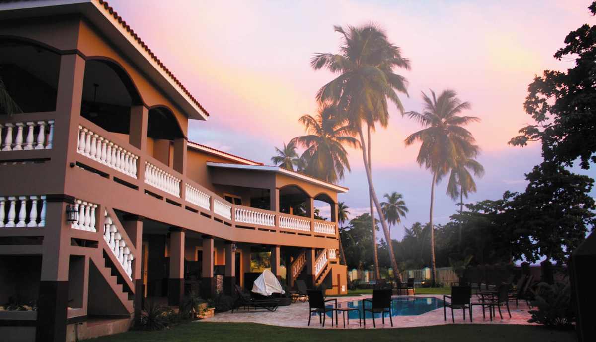 The villa facade glowing at sunset